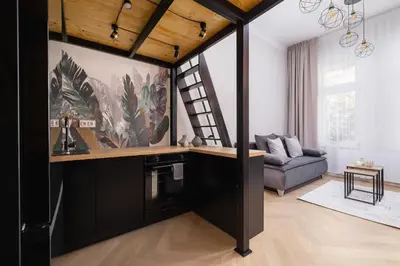a living room with a couch and a staircase at Studio apartment - Berka Joselewicza 5 street in Kraków