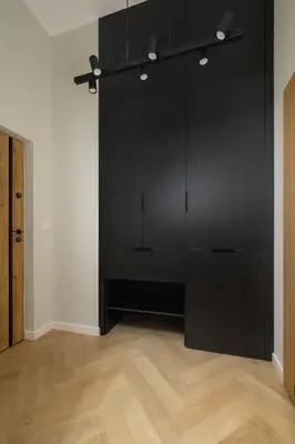 a black closet in a room with a wooden floor at Studio apartment - Berka Joselewicza 5 street in Kraków