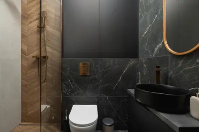 a bathroom with a black sink and a toilet at Studio apartment - Berka Joselewicza 5 street in Kraków