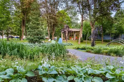a ferris wheel in a garden with flowers at Rabka City in Rabka-Zdroj