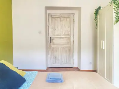 a room with a door and a blue pillow on the floor at Large 89m2 Apartment, 3 bedrooms and 2 bathrooms in Kraków