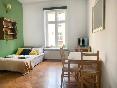 a living room with a couch and a table at Large 89m2 Apartment, 3 bedrooms and 2 bathrooms in Kraków