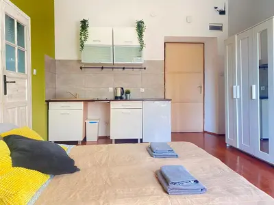 a kitchen with a large bed in a room at Large 89m2 Apartment, 3 bedrooms and 2 bathrooms in Kraków