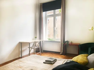 a living room with a table and a window at Large 89m2 Apartment, 3 bedrooms and 2 bathrooms in Kraków