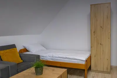 a living room with a bed and a couch at Ostoja w Górach in Bieńkówka