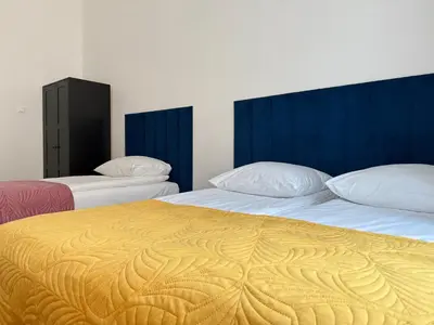 two beds in a room with two bedsskirts at Corner Apartments in Kraków
