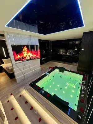 a living room with a pool and a fireplace at Masarska 6 VIP Apartamenty JACUZZI in Kraków