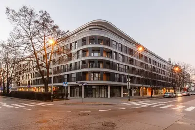 a large building on a city street at dusk at Masarska 6 VIP Apartamenty JACUZZI in Kraków