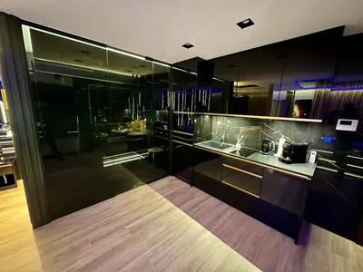 a kitchen with glass walls and a counter top at Masarska 6 VIP Apartamenty JACUZZI in Kraków