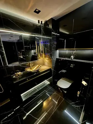 a black bathroom with a toilet and a sink at Masarska 6 VIP Apartamenty JACUZZI in Kraków