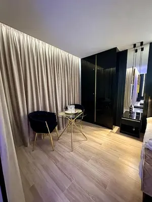 a room with a table and chairs and a bed at Masarska 6 VIP Apartamenty JACUZZI in Kraków