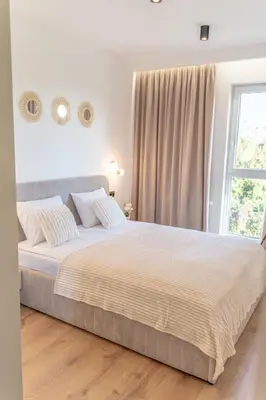 a bedroom with a large bed and a window at K&M Apartments Near Tauron Arena in Kraków