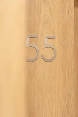 a wooden number on a wooden wall at K&M Apartments Near Tauron Arena in Kraków