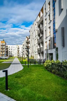a grassy area in front of a building at K&M Apartments Near Tauron Arena in Kraków