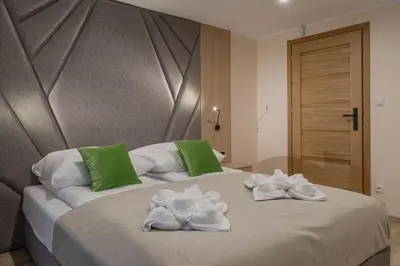 a bedroom with two towels on a bed at Zacisze pod Chełmem in Stryszów