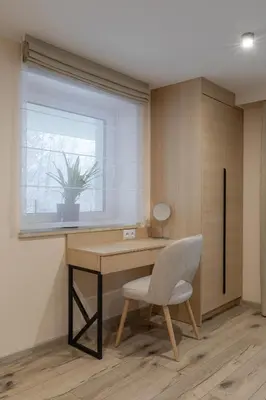 a desk and a chair in a room with a window at Zacisze pod Chełmem in Stryszów