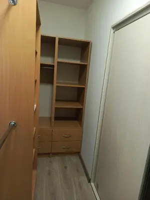 a kitchen with white cabinets and a wooden counter top at Apartament U ELI z prywatnym tarasem in Oświęcim