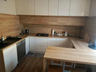 a kitchen with white cabinets and a counter top at Apartament U ELI z prywatnym tarasem in Oświęcim