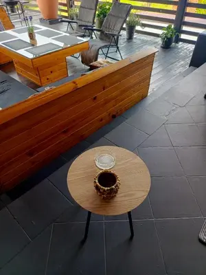 a wooden bench on a patio with a table at Apartament U ELI z prywatnym tarasem in Oświęcim