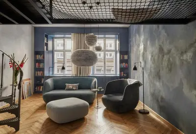 a living room with a couch and a chair at Luella in Kraków