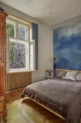 a bedroom with a bed and a painting on the wall at Luella in Kraków