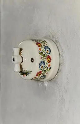 a white porcelain sink with a floral pattern on it at Luella in Kraków