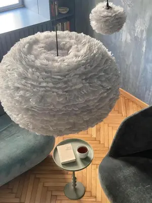 a large white lamp with a book on a table at Luella in Kraków