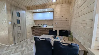 a small dining room with a table and chairs at Domek wypoczynkowy Górskie Zacisze II in Sidzina