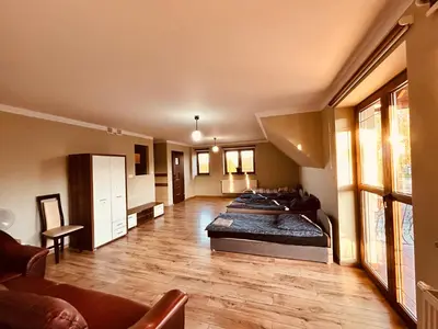 a large room with two beds and a couch at Noclegi Missterium in Wojnicz