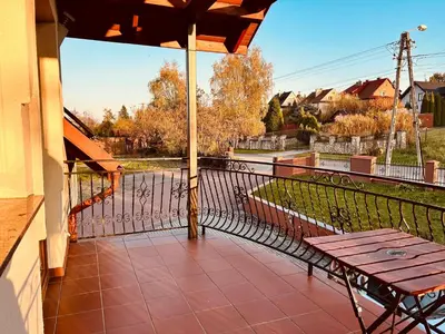 a balcony with a picnic table and a fence at Noclegi Missterium in Wojnicz