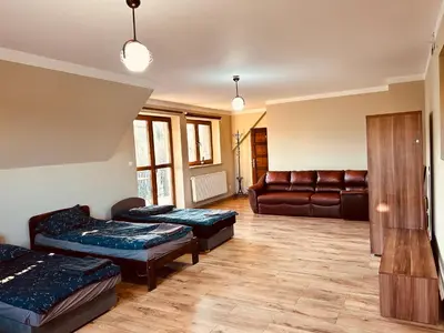 a living room with two beds and a couch at Noclegi Missterium in Wojnicz
