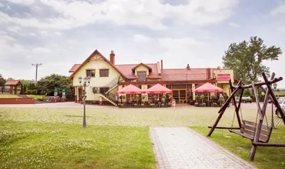 a playground in front of a building at Noclegi Missterium in Wojnicz