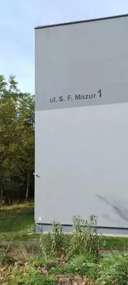a white building with a sign on the side of it at Na Podwalu in Jaworzno