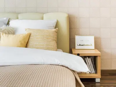 a bedroom with a bed and a side table with a picture at RentPlanet - Angel Plaza in Kraków