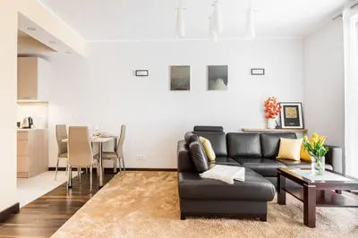 a living room with a couch and a table at RentPlanet - Angel Plaza in Kraków