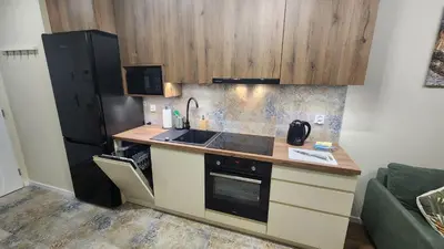 a small kitchen with a sink and a refrigerator at New 1-Bdrm Apt in Beautiful Kraków in Kraków
