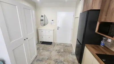 a kitchen with a white door and a mirror at New 1-Bdrm Apt in Beautiful Kraków in Kraków