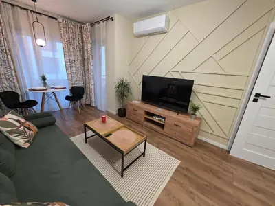 a living room with a couch and a flat screen tv at New 1-Bdrm Apt in Beautiful Kraków in Kraków