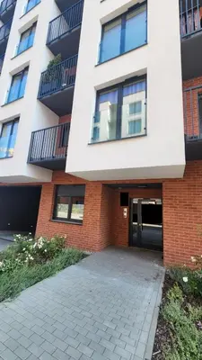 an apartment building with a driveway in front of it at New 1-Bdrm Apt in Beautiful Kraków in Kraków