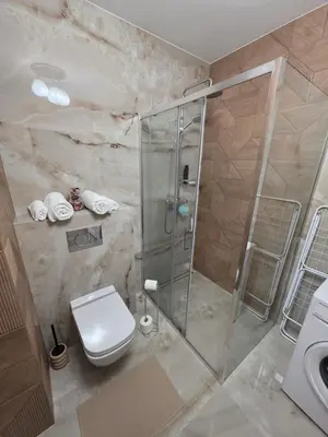 a bathroom with a shower and a toilet and a sink at New 1-Bdrm Apt in Beautiful Kraków in Kraków