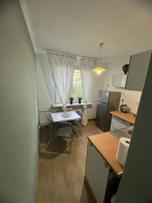 a kitchen with a table and chairs in a room at Mieszkaj u Marty stale na Stałym in Jaworzno