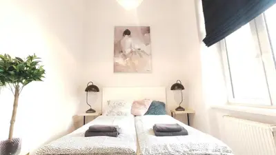 a bedroom with a bed with two pillows on it at Krowoderska 55 by Homeprime in Kraków