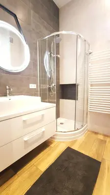 a bathroom with a shower and a white sink at Krowoderska 55 by Homeprime in Kraków