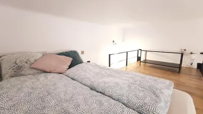 a bed with a pink pillow on top of it at Krowoderska 55 by Homeprime in Kraków