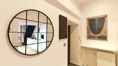 a mirror on the wall of a bathroom at Krowoderska 55 by Homeprime in Kraków
