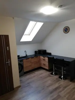 a kitchen with a counter and a sink and a window at Olszynowy Gaj 4 in Liszki