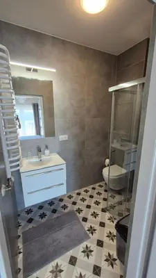 a bathroom with a sink and a toilet and a mirror at Olszynowy Gaj 4 in Liszki