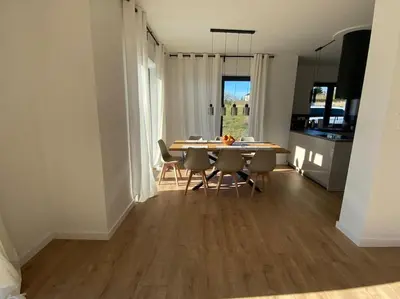 a kitchen and dining room with a table and chairs at Słoneczna przystań pod Luboniem in Rabka
