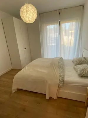 a bedroom with a bed with a large window at Słoneczna przystań pod Luboniem in Rabka