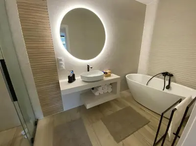 a bathroom with a tub and a sink and a mirror at Słoneczna przystań pod Luboniem in Rabka